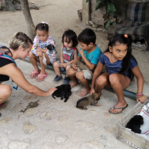 Woman and kids with puppies